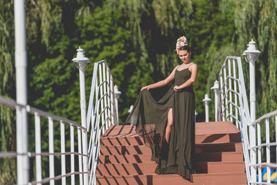 Portrait of woman against railing