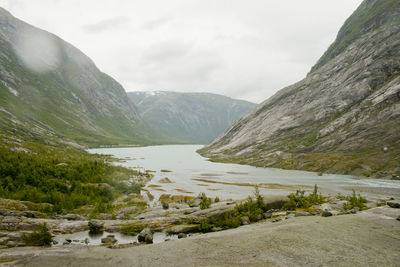 Scenic view of lake and mountains against sky