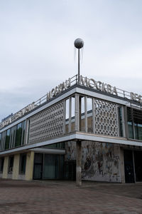 Low angle view of building against cloudy sky