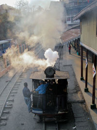 People working on railroad track in city