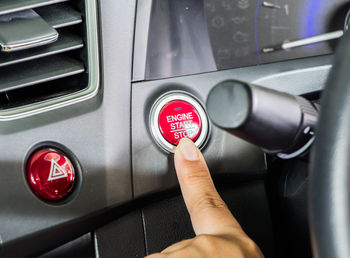 Cropped image of hand holding machine part of car