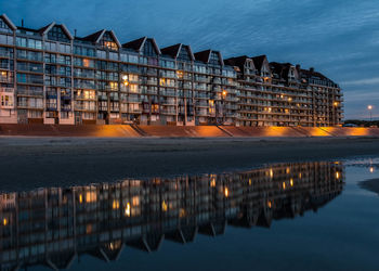 Reflection of illuminated buildings in city at night