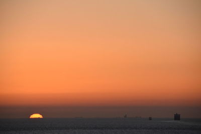 Scenic view of sea against orange sky