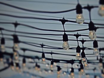 Close-up of light bulb against sky