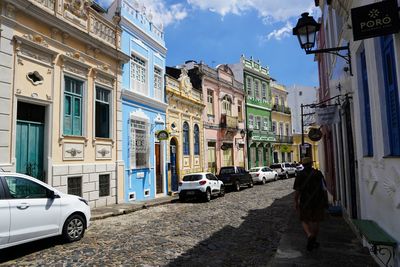 People walking on street amidst buildings in city