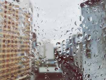 Full frame shot of wet glass window in rainy season