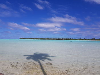 Scenic view of beach against blue sky