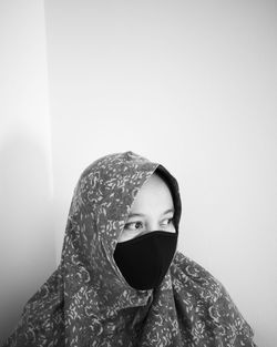 Woman wearing mask at home