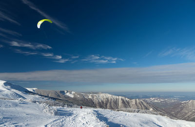 Scenic view of snowcapped mountains against sky