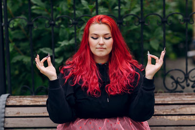 Portrait of beautiful young woman using phone while standing outdoors