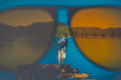 Reflection of trees in lake against sky