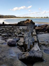 Rocks on beach against sky