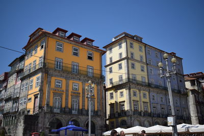 Low angle view of buildings against blue sky