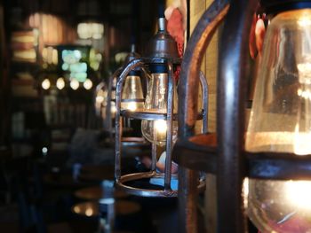 Close-up of illuminated lamp hanging on table in restaurant