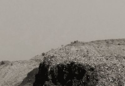 Rock formation on land against clear sky