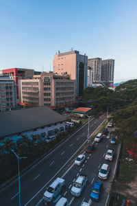 High angle view of city street and buildings against sky