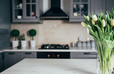 Flower vase on table at home