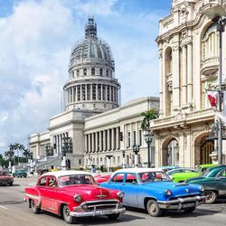 Cars in city against sky