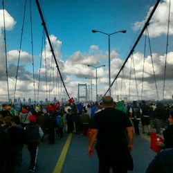 Group of people in front of cloudy sky