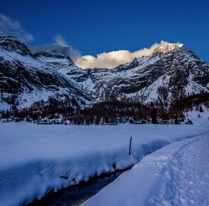 Scenic view of snow covered mountains against sky