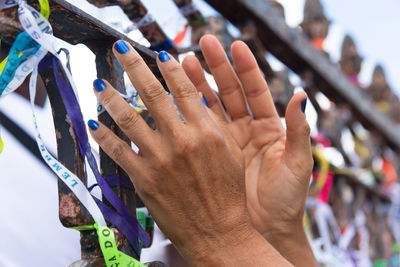  people are seen paying homage to senhor do bonfim by tying a souvenir ribbon