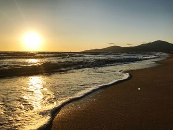 Scenic view of beach against sky during sunset