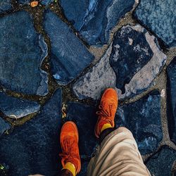 Low section of man standing on footpath