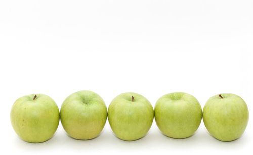 Close-up of fruits over white background