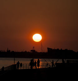 Silhouette of people on beach during sunset