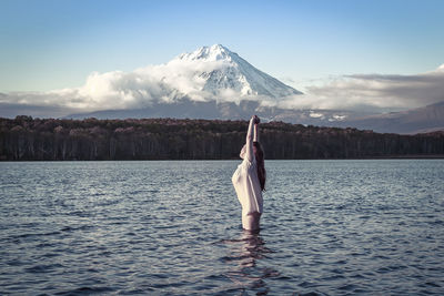 Full length of woman in lake against sky