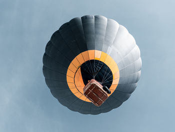 Low angle view of starting hot air balloon against sky