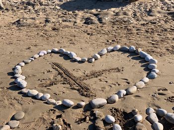 High angle view of heart shape on sand