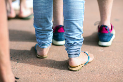 Low section of people standing on road