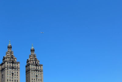 Low angle view of buildings against clear blue sky