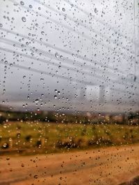 Full frame shot of wet glass window in rainy season