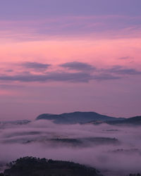 Scenic view of silhouette mountains against romantic sky at sunset