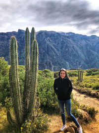 Full length portrait of woman with huge cactus 