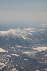 Aerial view of snowcapped mountains against sky