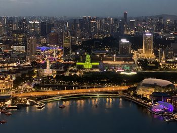 Illuminated buildings in city against sky at night