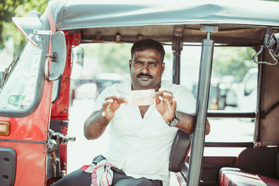 Portrait of man sitting in bus