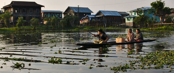 Boats in river with buildings in background