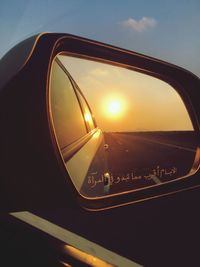 View of sunset seen through car window