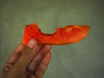 Close-up of hand holding strawberry