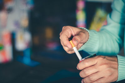Midsection of man smoking cigarette