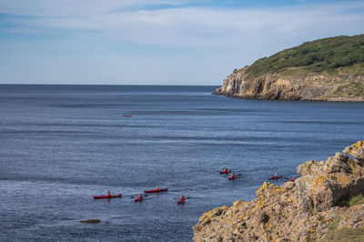 Kayakers at hammeren harbour, bornholm, denmark
