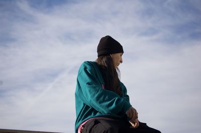 Low angle view of man standing against sky