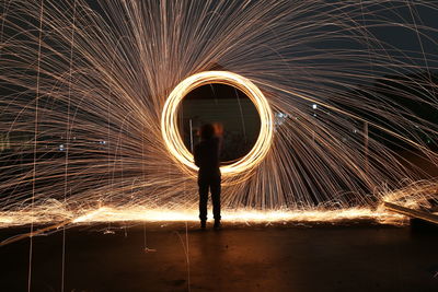 Blurred motion of man standing in tunnel