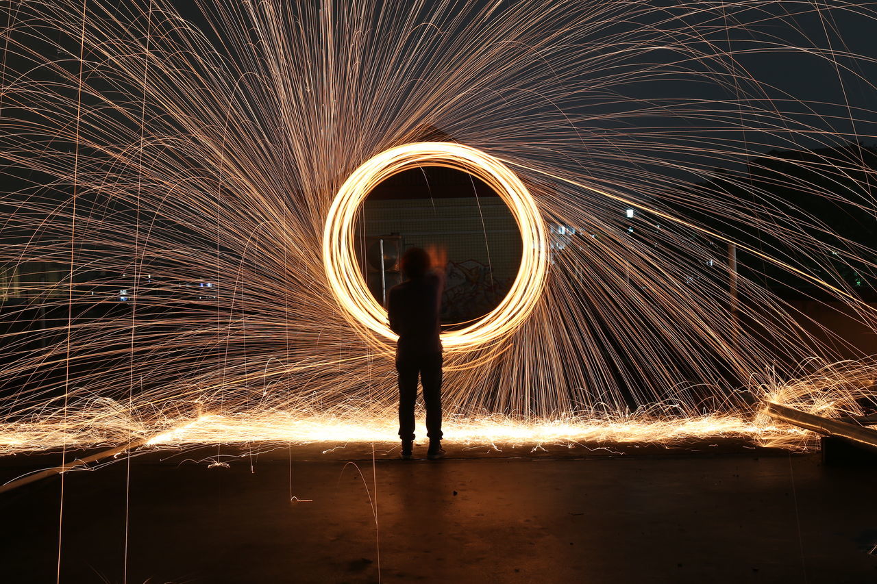 lifestyles, full length, silhouette, standing, leisure activity, tunnel, indoors, illuminated, rear view, night, water, walking, men, circle, person, wet, rain, reflection