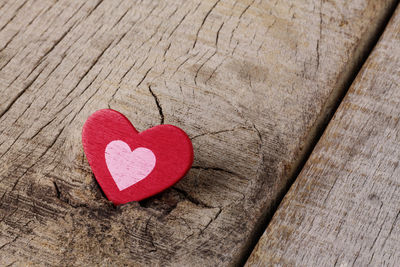 Close-up of red heart shape on wooden table