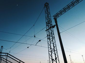 Low angle view of electricity pylon against sky